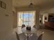 Bright breakfast nook with sliding glass doors that lead to a screened-in pool area with outdoor seating at 11405 Warm Wind Way, Weeki Wachee, FL 34613
