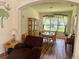 Inviting dining room filled with natural light, beautiful hardwood floors, and elegant furniture at 11405 Warm Wind Way, Weeki Wachee, FL 34613