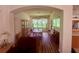 Cozy dining room featuring hardwood floors, classic chandelier, and sun-filled windows at 11405 Warm Wind Way, Weeki Wachee, FL 34613