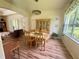 Charming dining area features elegant chandelier, decorative china cabinet, and large window at 11405 Warm Wind Way, Weeki Wachee, FL 34613