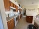 Well-maintained kitchen features oak cabinets, white appliances, and a spacious island at 11405 Warm Wind Way, Weeki Wachee, FL 34613