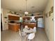 Open kitchen layout with oak cabinets, white appliances, and breakfast bar seating at 11405 Warm Wind Way, Weeki Wachee, FL 34613
