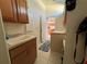 Convenient laundry room featuring a sink, cabinets, and tiled floor; perfect for household chores at 11405 Warm Wind Way, Weeki Wachee, FL 34613