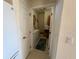 View into functional laundry room from the kitchen with washer, dryer, and storage at 11405 Warm Wind Way, Weeki Wachee, FL 34613