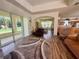 Bright and airy living room with hardwood floors, sliding glass doors to the outdoor patio at 11405 Warm Wind Way, Weeki Wachee, FL 34613