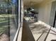 Inviting screened patio with ceiling fan and swing, perfect for relaxation and outdoor enjoyment at 11405 Warm Wind Way, Weeki Wachee, FL 34613