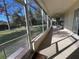 Large screened-in patio with ceiling fan and outdoor seating, overlooking a spacious backyard at 11405 Warm Wind Way, Weeki Wachee, FL 34613