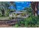 Yellow house with metal roof, surrounded by trees at 13515 Gavin Rd, Dover, FL 33527
