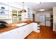 Spacious kitchen featuring white cabinets, wood countertops, and a decorative light fixture at 160 Bayshore Dr, Terra Ceia, FL 34250