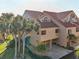 An aerial view of the home highlights the tile roof, balconies, and lush landscaping at 1630 Royal Palm S Dr # A, St Petersburg, FL 33707