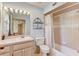 Clean bathroom with light beige tile, a shower/tub combo, and a vanity with storage at 1630 Royal Palm S Dr # A, St Petersburg, FL 33707