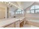 Bathroom features a large vanity, soaking tub, and updated tile flooring at 1630 Royal Palm S Dr # A, St Petersburg, FL 33707