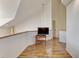 Upper hallway with hardwood floors and mounted TV at 1630 Royal Palm S Dr # A, St Petersburg, FL 33707
