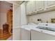 Convenient laundry room with washer, dryer, and built-in shelving at 1630 Royal Palm S Dr # A, St Petersburg, FL 33707
