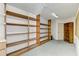 Large storage room with wood shelving units and ample space at 1630 Royal Palm S Dr # A, St Petersburg, FL 33707