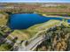 Aerial view of community lake, golf course, and residential area at 19301 Sandy Springs Cir, Lutz, FL 33558