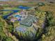 Aerial view of community with sports courts and a pond at 19301 Sandy Springs Cir, Lutz, FL 33558