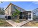 The backyard with a pool, screened enclosure, and beautiful landscaping at 19301 Sandy Springs Cir, Lutz, FL 33558
