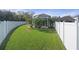 Landscaped backyard with a view of the pool and screened enclosure at 19301 Sandy Springs Cir, Lutz, FL 33558