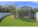 Landscaped backyard with pool and screened enclosure at 19301 Sandy Springs Cir, Lutz, FL 33558