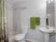 Clean bathroom with tub shower combo and pedestal sink at 19301 Sandy Springs Cir, Lutz, FL 33558