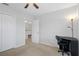 Bedroom with desk, chair, and double door closet at 19301 Sandy Springs Cir, Lutz, FL 33558
