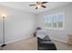 Bright bedroom with ceiling fan and large window at 19301 Sandy Springs Cir, Lutz, FL 33558