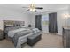 Spacious bedroom with king-size bed and ceiling fan at 19301 Sandy Springs Cir, Lutz, FL 33558