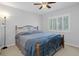 Bedroom with queen bed and window shutters at 19301 Sandy Springs Cir, Lutz, FL 33558