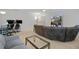 Bonus room with sectional sofa and large TV at 19301 Sandy Springs Cir, Lutz, FL 33558