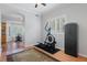 Home exercise room with elliptical machine, hardwood floors, and large windows at 19301 Sandy Springs Cir, Lutz, FL 33558