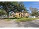 Two story house with tan exterior, landscaping, and a two-car garage at 19301 Sandy Springs Cir, Lutz, FL 33558