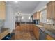 Open kitchen with ample cabinetry, granite counters, and tile flooring at 19301 Sandy Springs Cir, Lutz, FL 33558