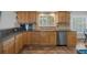 Modern kitchen with wood cabinets, granite countertops, and stainless steel dishwasher at 19301 Sandy Springs Cir, Lutz, FL 33558