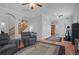 Living room with hardwood floors, ceiling fan, and elliptical exercise machine at 19301 Sandy Springs Cir, Lutz, FL 33558