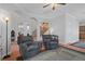 Comfortable living room with hardwood floors, two armchairs, and access to other rooms at 19301 Sandy Springs Cir, Lutz, FL 33558