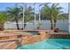 Enjoy the waterfall spa adjacent to the refreshing pool at 19301 Sandy Springs Cir, Lutz, FL 33558