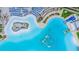 Crystal Lagoon amenity with beach, lounge chairs, and water features at 31639 Blue Passing Loop, Wesley Chapel, FL 33545