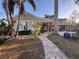 Back of house with patio, walkway, and landscaping at 4010 Belle Vista Dr, St Pete Beach, FL 33706