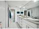 Double vanity bathroom with a large mirror and shower at 4650 Bay Blvd # 1046, Port Richey, FL 34668