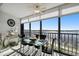 Glass dining table and chairs situated in front of expansive water views at 4650 Bay Blvd # 1046, Port Richey, FL 34668