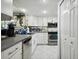 Modern white kitchen with stainless steel appliances and granite countertops at 4650 Bay Blvd # 1046, Port Richey, FL 34668