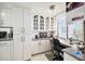 Built-in home office with glass-front cabinets and granite countertop at 4650 Bay Blvd # 1046, Port Richey, FL 34668