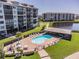 Community pool with patio furniture and adjacent building at 4650 Bay Blvd # 1046, Port Richey, FL 34668