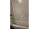 White bathtub/shower combo with tiled walls at 6023 Osprey Lake Cir, Riverview, FL 33578