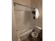 Bathroom with white bathtub, toilet, and tiled walls at 6023 Osprey Lake Cir, Riverview, FL 33578