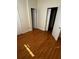 Sunlit bedroom with wood-look flooring and several doors at 6023 Osprey Lake Cir, Riverview, FL 33578