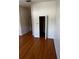 Empty bedroom with wood-look laminate floors and open closet door at 6023 Osprey Lake Cir, Riverview, FL 33578