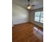 Empty bedroom with wood-look laminate floors, ceiling fan, and window at 6023 Osprey Lake Cir, Riverview, FL 33578