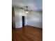 Empty bedroom with wood-look laminate floors, ceiling fan, and closet door at 6023 Osprey Lake Cir, Riverview, FL 33578